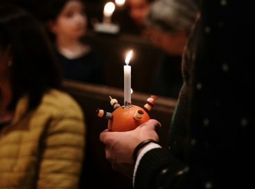 a person holding a candle in their hand