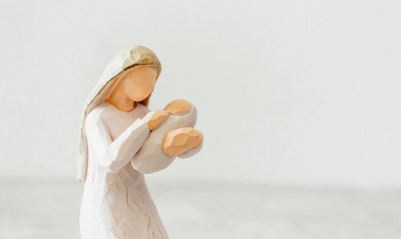 a figurine of a woman holding a baby jesus