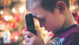 boy holding Holy Bible