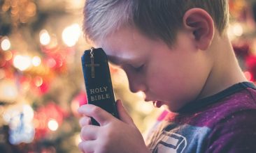 boy holding Holy Bible