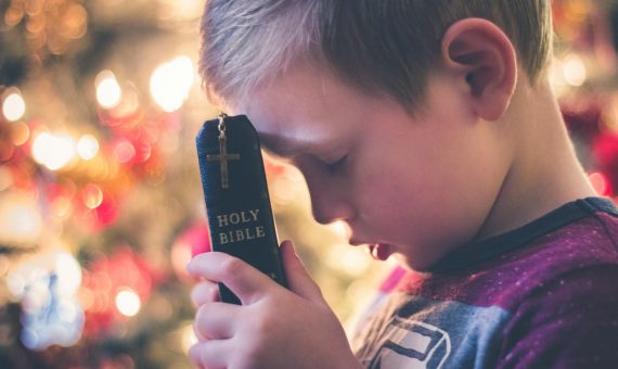 boy holding Holy Bible
