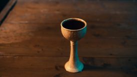 a small cup sitting on top of a wooden table