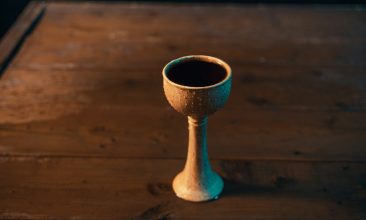 a small cup sitting on top of a wooden table