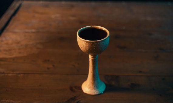 a small cup sitting on top of a wooden table