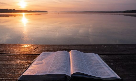 book on top of table and body of water