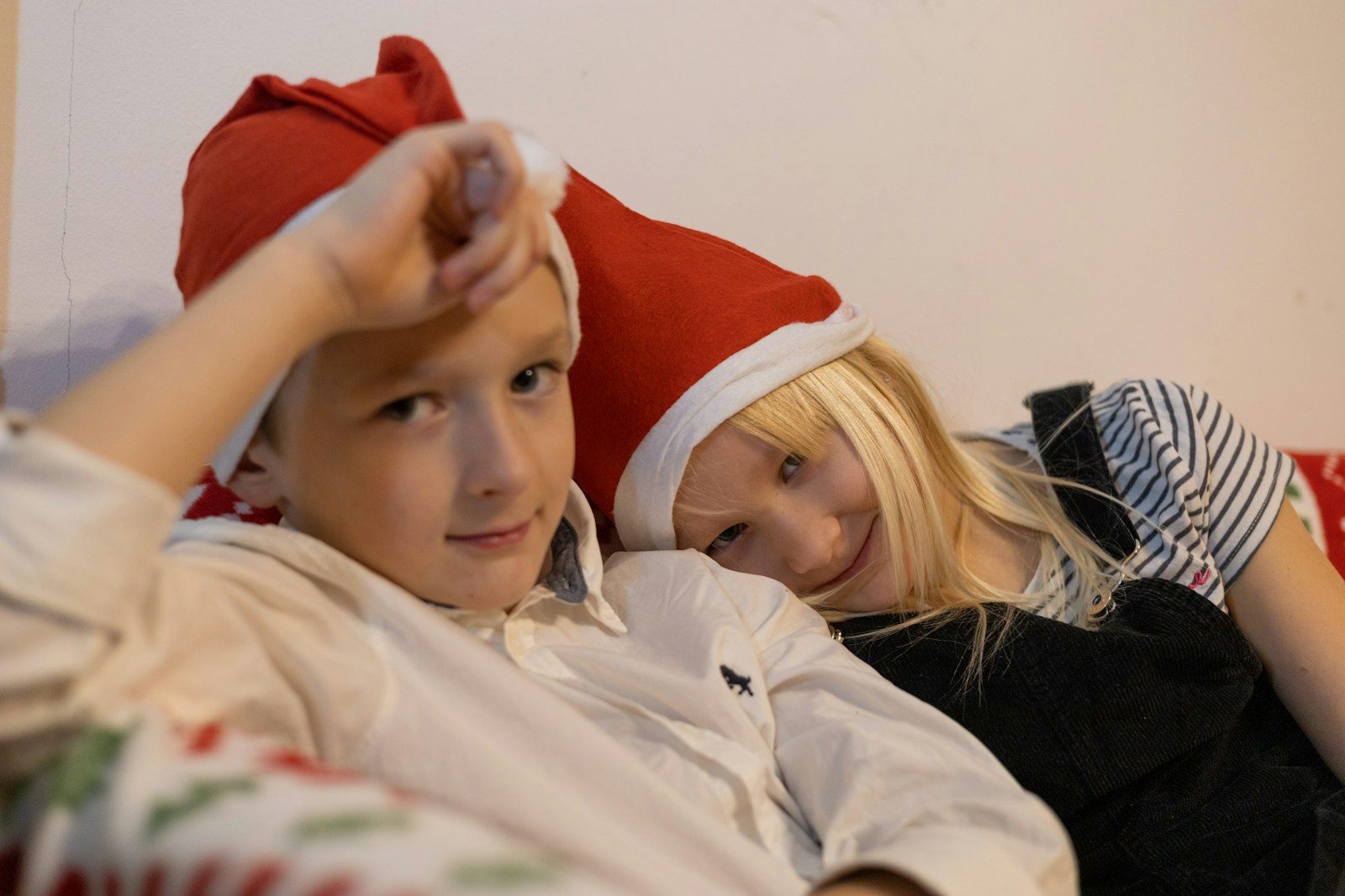 a man and woman wearing santa hats