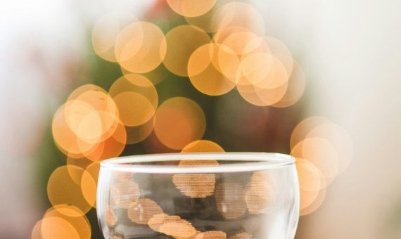 a glass of wine sitting on top of a plate