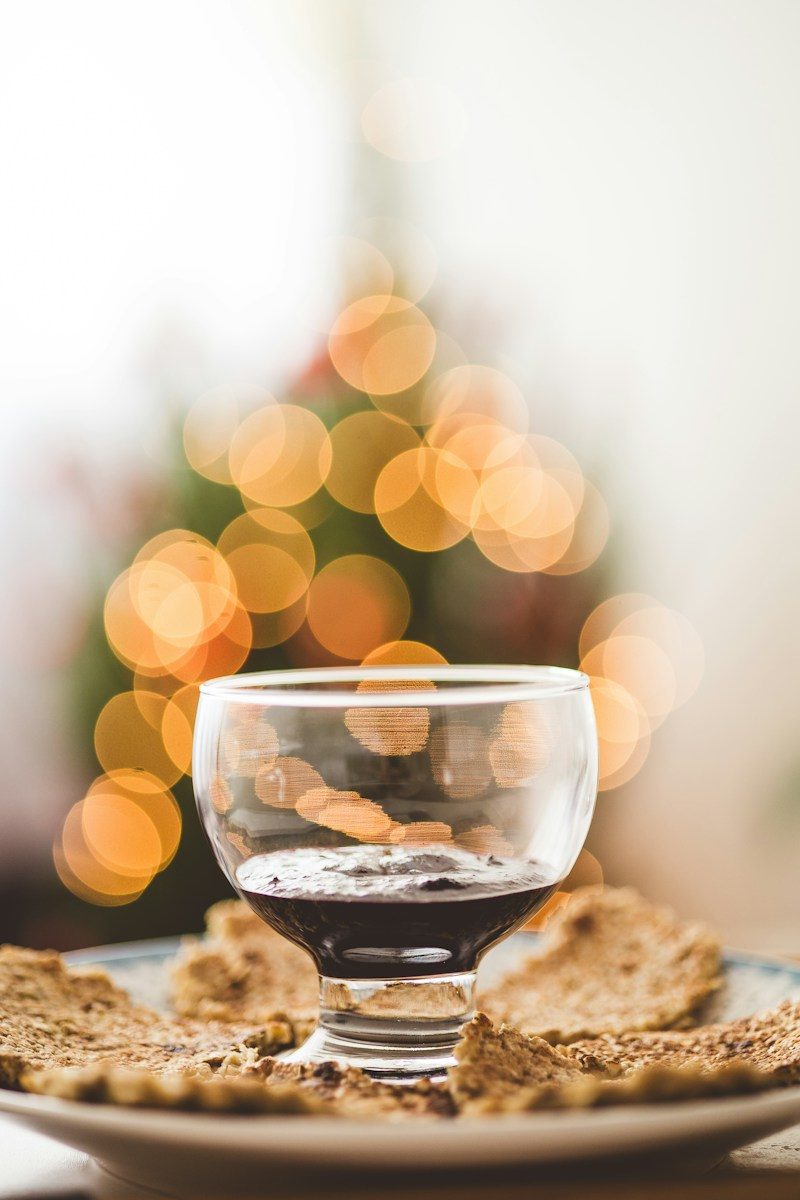 a glass of wine sitting on top of a plate